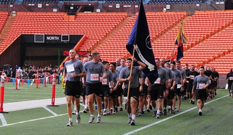Runners crossing the finish line of the Great Aloha Run at Aloha Stadium